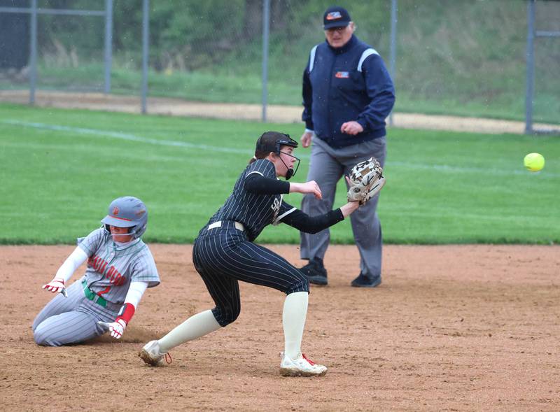 LaSalle-Peru's Karmen Piano slides in with a stolen base as Sycamore's Callie Countryman waits for the throw Thursday, April 30, 2026, during their game at Sycamore High School.
