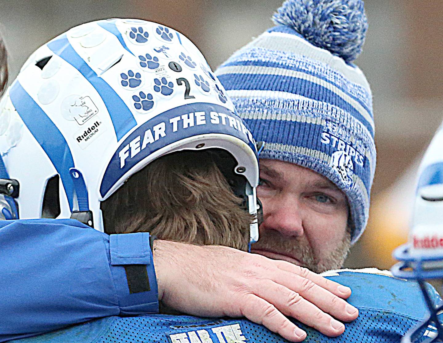 Princeton head coach Ryan Pearson hugs quarterback Teegan Davis after loosing to IC Catholic in the Class 3A Quarterfinal game on Saturday, Nov. 12, 2022 in Princeton.