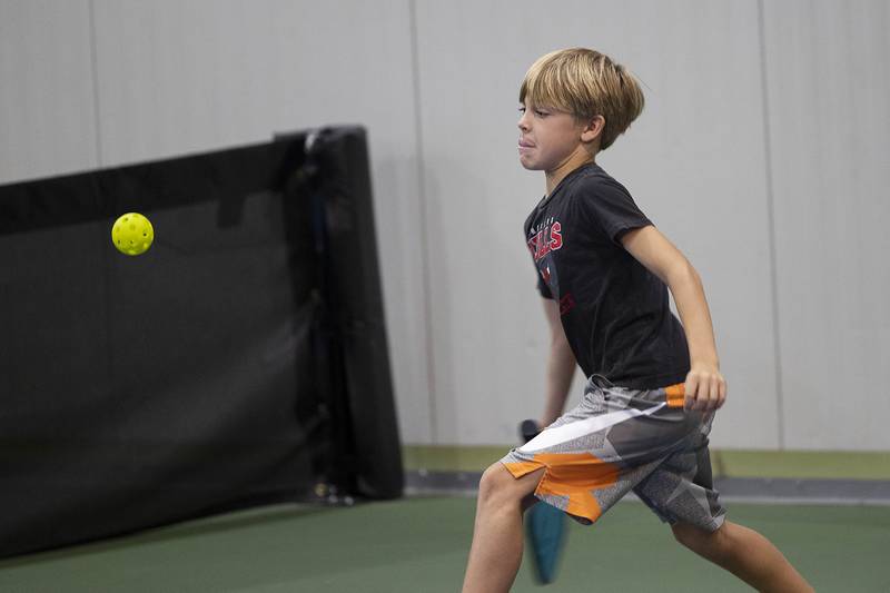 A St. Anne’s student eyes the ball Wednesday, Sept. 17, 2025, while playing pickleball in Sterling. Students learned the rules of the game from Westwood instructor Chris Duffy.