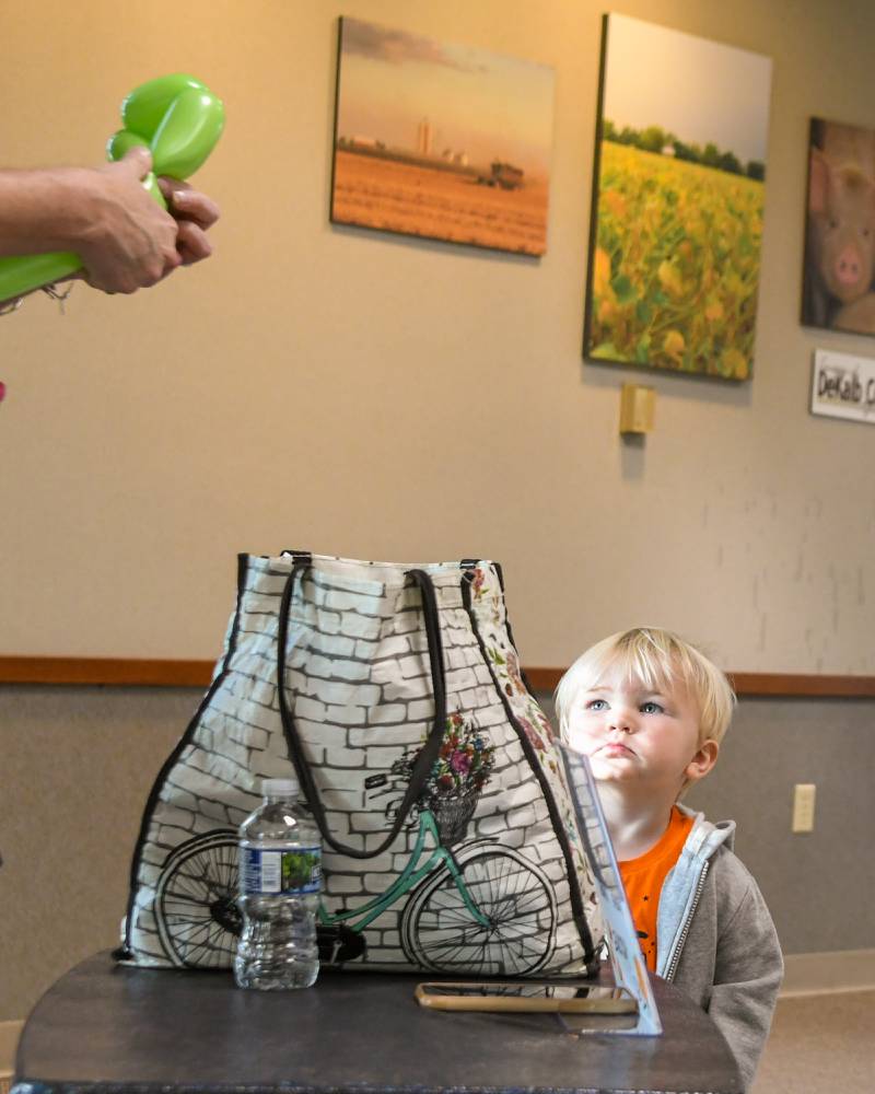 Mac McLaughlin 2,of DeKalb watches intently as a balloon turttle gets made for his sister on Sunday Oct. 12, 2025, during the DeKalb County 4-H carnival held at the DeKalb Farm Bureau in Sycamore.
