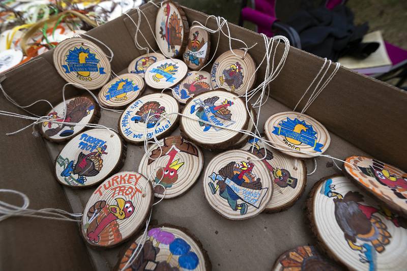 Winners' medals for St. Anne’s Turkey Trot 5K were hand painted by Candace Buikema and Gerald Stock for the race on Thursday, Nov. 28, 2024.