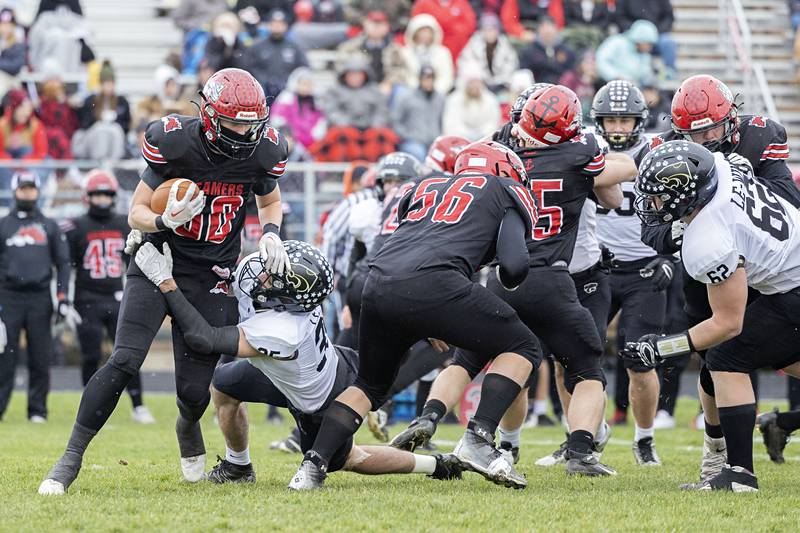 Fulton’s Lukas Schroeder is hauled down in the backfield Saturday, Nov. 12, 2022 in a quarterfinal game against Le/Win.