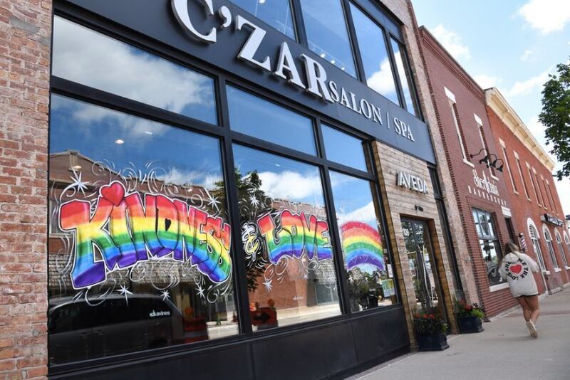 A display of LGBTQ+ Pride art adorned the window of C'zar Salon Spa on Main Street in downtown Wheaton last year. The city plans to issue a proclamation recognizing Pride later this month. (Paul Valade | Staff Photographer, June 2020)