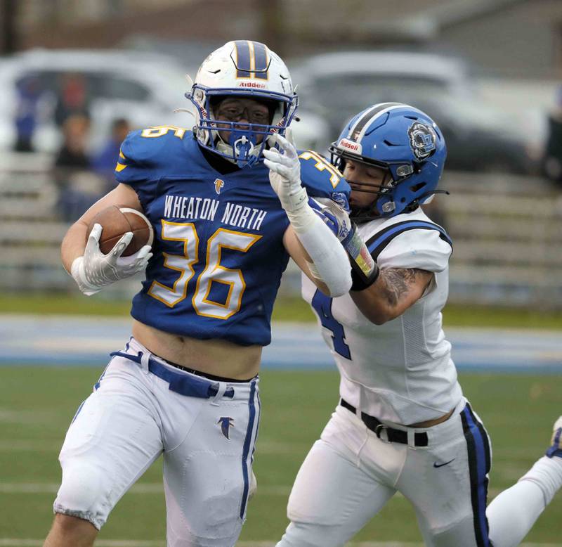 Brian Hill/bhill@dailyherald.com
Wheaton North's Kyle Both (36) tries to slide past Lake Zurich's Coplan Oettinger (4) during the second round of the IHSA playoffs Saturday November 5, 2022 in Wheaton.