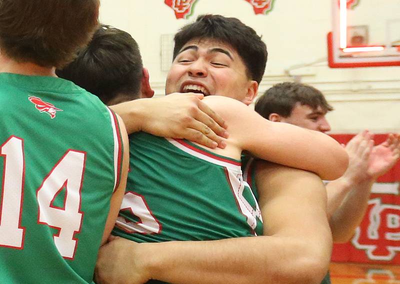 L-P's Andy Medina hugs teammate Erick Sotelo after winning the Class 3A Regional title game against Streator on Friday, Feb. 28, 2025 in Sellett Gymnasium at L-P High School.