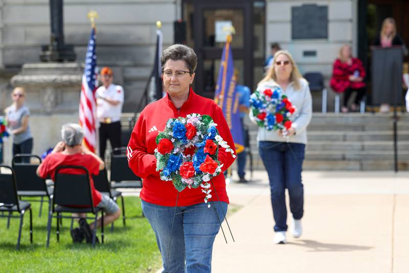 State Representative Jackie Haas helps place wreaths on Monday, May 26, 2025, during the Kankakee County Veterans' Council annual Memorial Day Ceremony at the Kankakee County Courthouse.