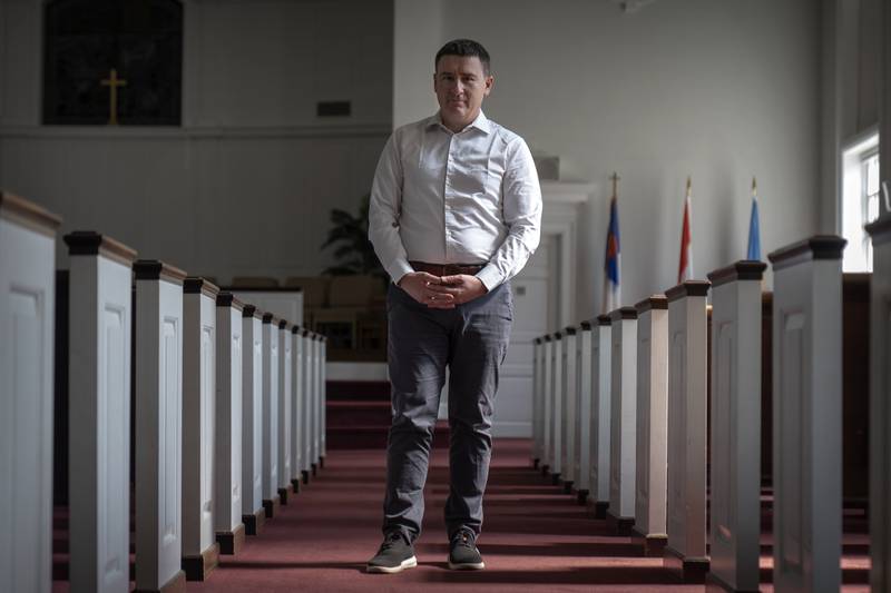 Slavik Pyzh, the president of the Ukrainian Baptist Theological Seminary in Lviv, Ukraine, stands in the sanctuary of a Baptist church in Arlington, Va., Tuesday, Sept. 3, 2024. (AP Photo/Mark Schiefelbein)