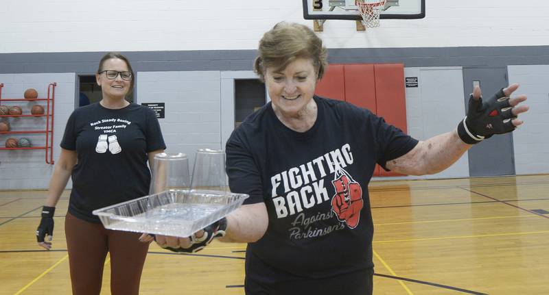 Elaine McKinney conducts a drill during her Rocksteady Boxing class at Streator YMCA as instructor Nichole Reynolds watches.