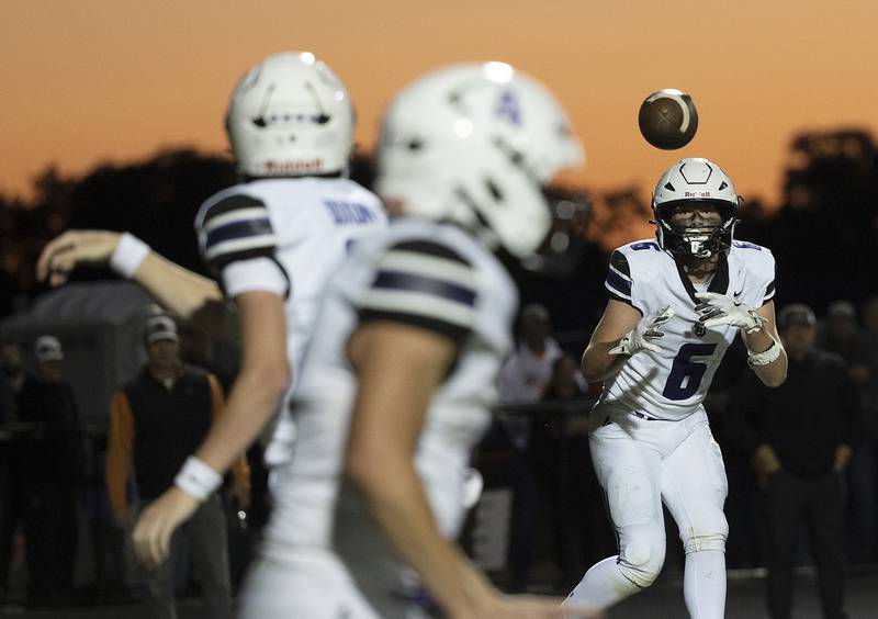 Dixon’s Logan Mershon catches a pass against Byron Friday, Sept. 5, 2025, at Byron High School.

The early football season orange sky, coupled with a clean image of players in action set this piece apart in my opinion.