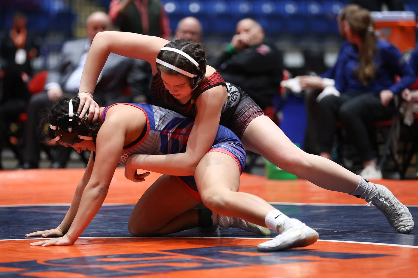 Batavia’s Sydney Perry works over West Aurora Dyani Rivera in the 145 pound championship match at Grossinger Motor Arena in Bloomington. Saturday, Feb. 26, 2022, in Champaign.