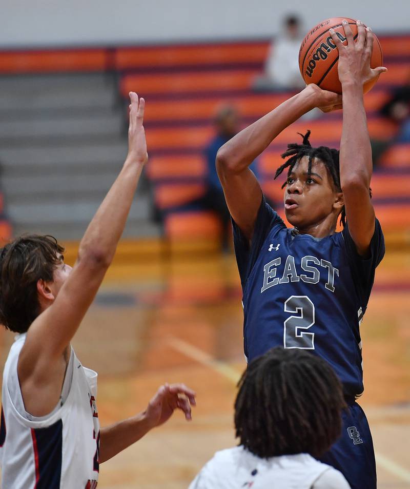 Oswego East's Mason Lockett IV (2) shoots from three point range during a Hoops for Healing tournament game against West Aurora on Nov. 20, 2023 at Naperville North High School in Naperville.
