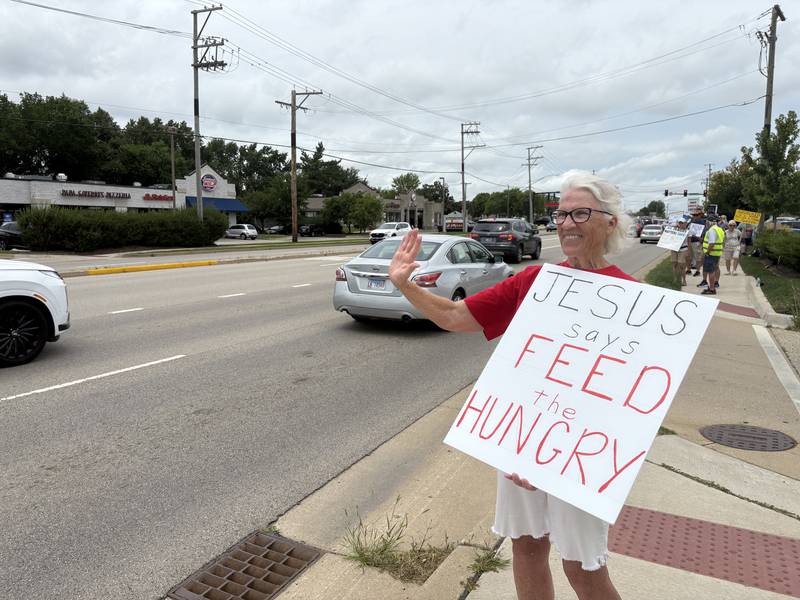 Gail Kyle holds up a sign during a protest in McHenry July 26, 2025.