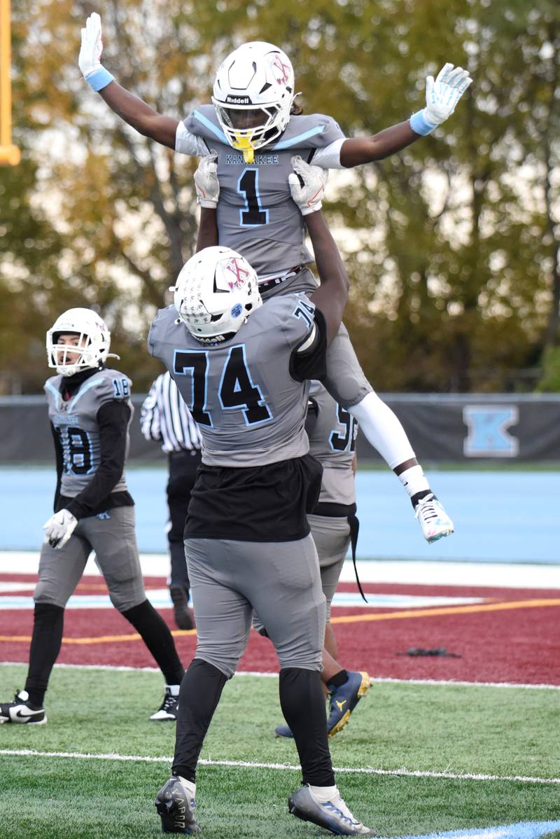 Kankakee's Kymani Billings (1) is hoisted in the air by Jeremiah Watson after scoring a touchdown during an IHSA Class 5A playoff game against Lemont at Kankakee Saturday. Nov. 1, 2025.