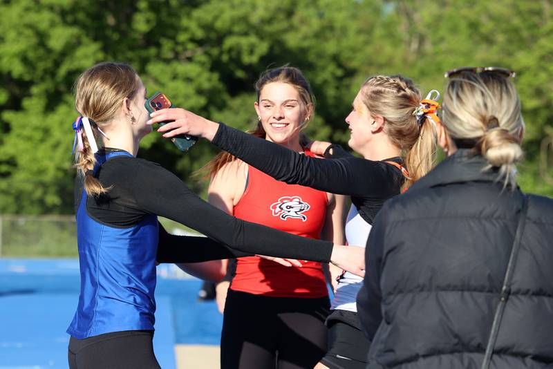 Lincoln-Way East's Teagan Knipper, left, runs to hug fellow high jump state qualifiers Lincoln-Way Central's Nicole Demma, center, and Lincoln-Way West's Mia DiBenedetto during the IHSA Class 3A Chicago Heights Girls Track and Field Sectional at Bloom High School on Wednesday, May 13, 2026.