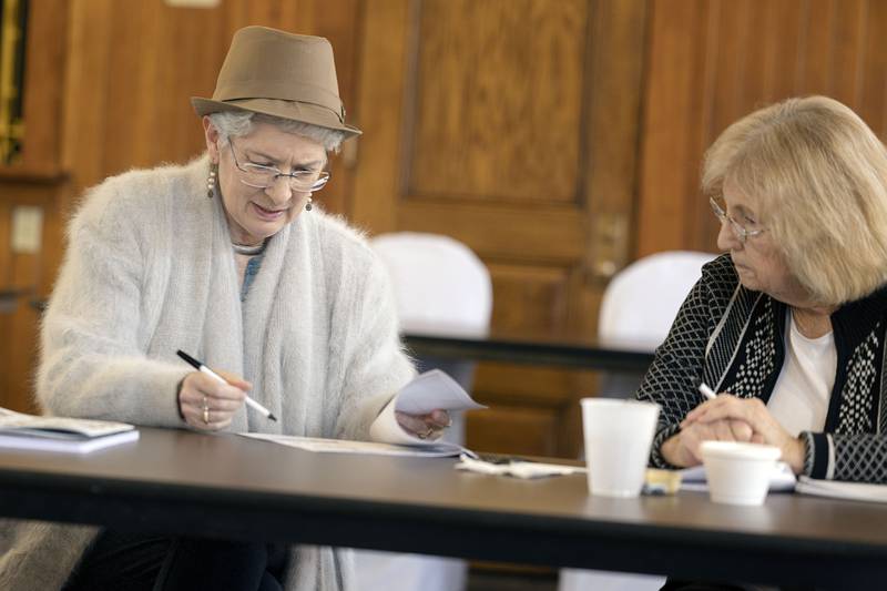 Jeanne Byers-Spraetz (left) of Savanna and Judy Schmidt of Polo compare notes Friday during the writing workshop.