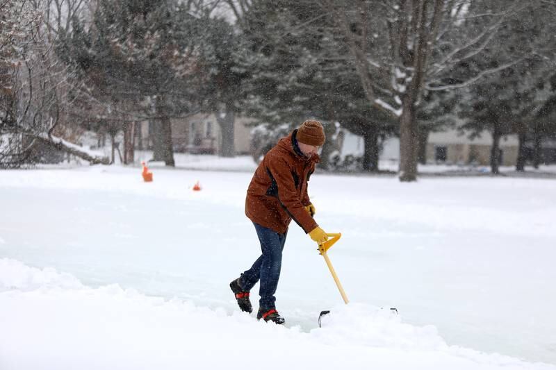 Sugar Grove Park District employee Scott Nadeau clears snow from the ice rink on Friday, Jan. 10, 2025 behind the Sugar Grove Township Community Building. The rink, which is possible through a partnership between the Sugar Grove Park District, Sugar Grove Township Sugar Grove Fire Protection District and Village of Sugar Grove,  is frozen and ready for skaters.