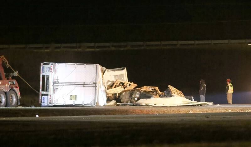 A wrecker removes a semi truck that tipped over on it's side on Thursday, Jan. 9, 2024 near the Spring Valley exit on Interstate 80 near Ladd. A cattle hauler tipped over allowing cows to roam on Interstate 80.