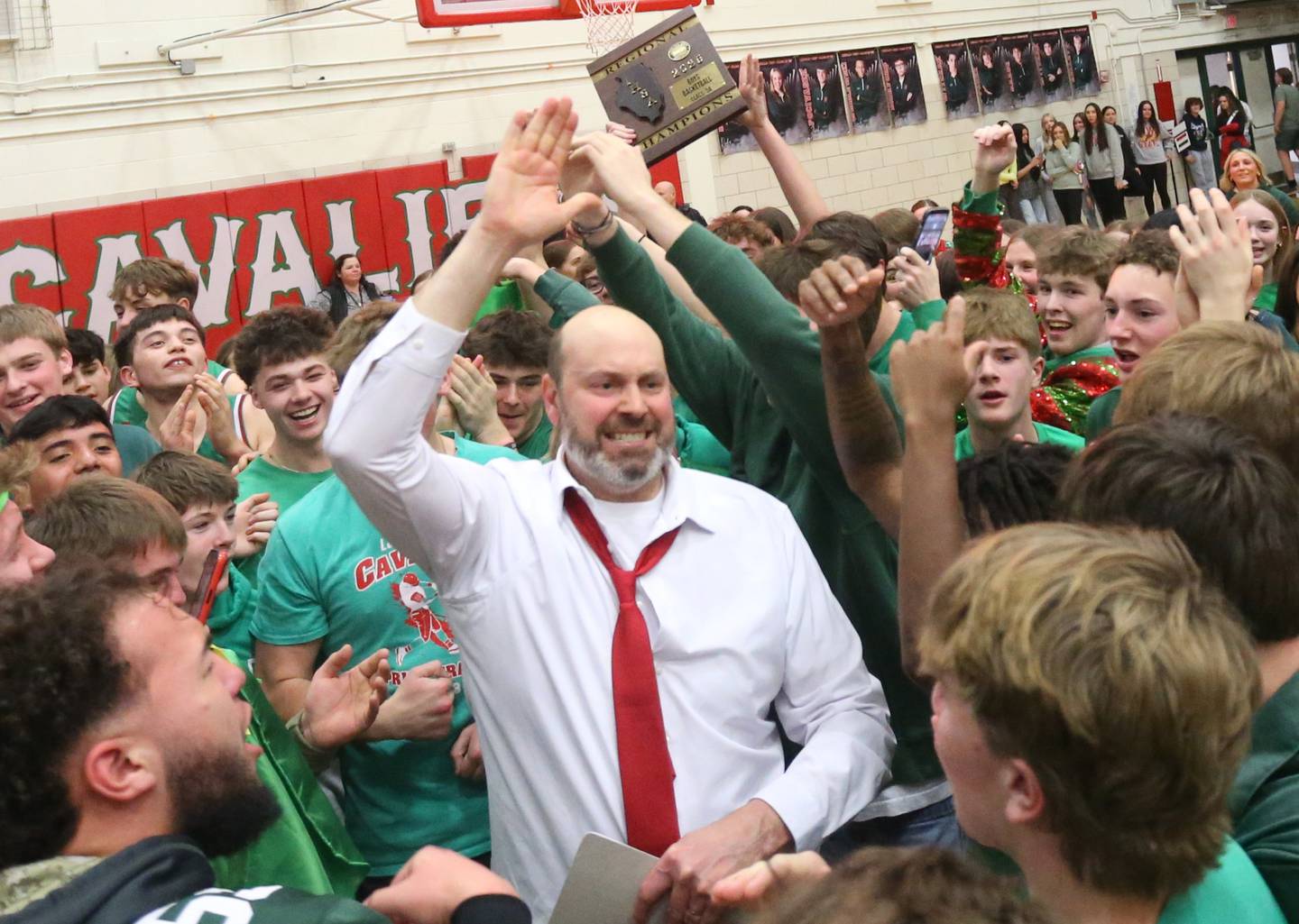 L-P head boys basketball coach John Senica hi-fives L-P super fans after winning the Class 3A Regional title game against Streator on Friday, Feb. 28, 2025 in Sellett Gymnasium at L-P High School.