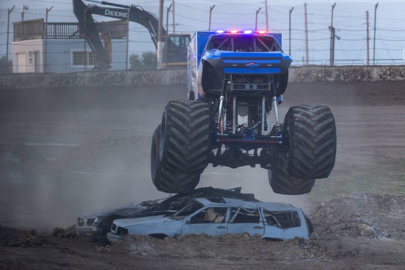 Driver of the Monster Truck 'Rescue Racer' flies over 3 cars and ramp at the Monster Truck Bash on Saturday, Sept. 13, 2025 at the La Salle Speedway in La Salle.