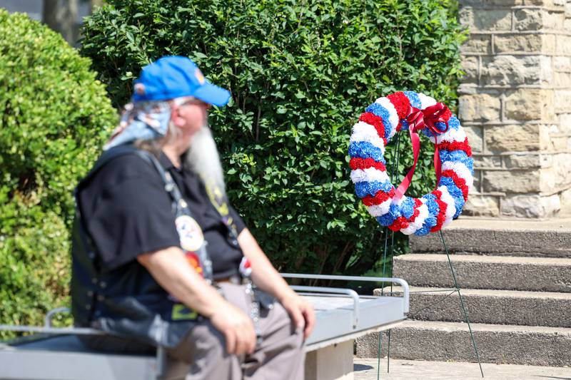 A veteran sits near a memorial wreath, which was dedicated to the late US Army veteran Maurice Norington, who died during the March 10 Aroma Township tornado, during the Bradley American Legion's Memorial Day ceremony on Monday, May 25, 2026.