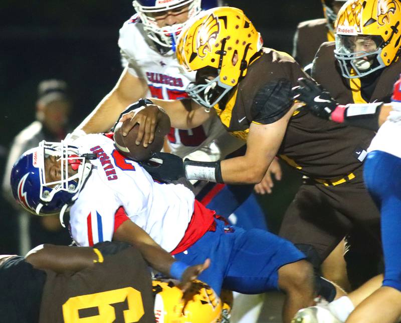 Dundee-Crown’s Kadin Malone is brought down by a host of Golden Eagles in varsity football  at Jacobs High School in Algonquin on Friday, Oct. 10, 2025.