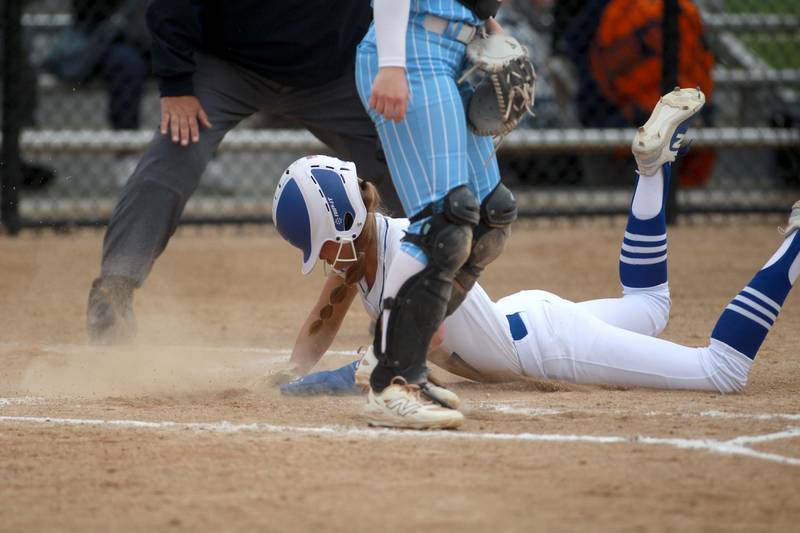 St. Charles North's Mack Patterson slides into home plate during a game against Lake Park on Wednesday, April 30, 2025 in St. Charles.