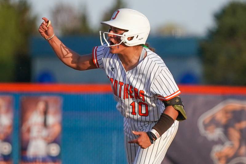 Oswego’s Kiyah Chavez (10) reacts after hitting a two run double against Minooka during a Southwest Prairie Conference softball game at Oswego High School on Wednesday, April 23, 2025.