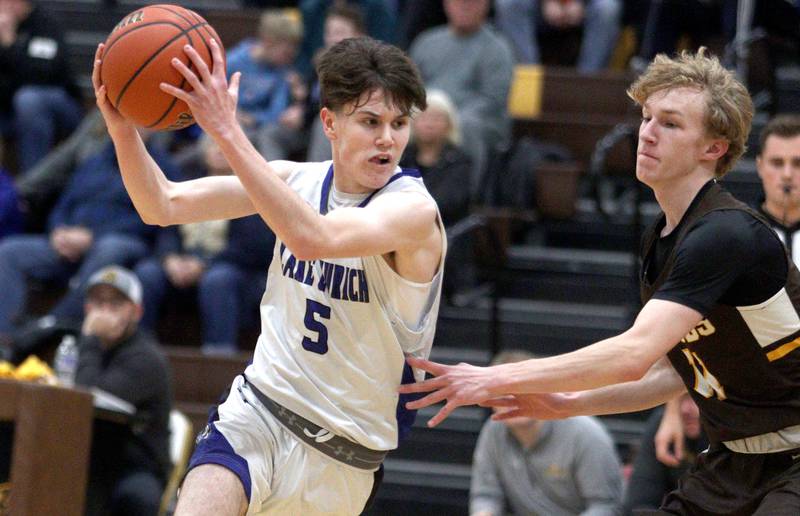 Jacobs’ Max Fessler, right, guards Lake Zurich’s Ryan Carroll in Hinkle Holiday Classic boys basketball tournament game action at Jacobs High School Tuesday.