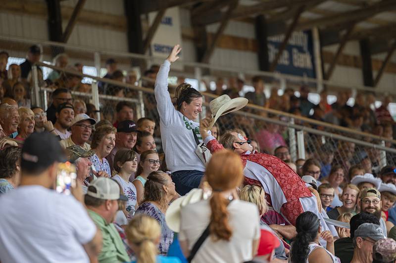 Missy Foster of Prophetstown and entertainer Hippie Engelkes show off their bronc riding skills Wednesday, August 14, 2024, at the Whiteside County Fair in Morrison.