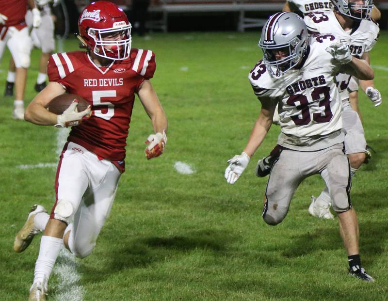 Hall's Joseph Bacidore carries the football as Illinois Valley Central's Griffin Goines defends on Friday, Sept. 29, 2023 at Richard Nesti Stadium.