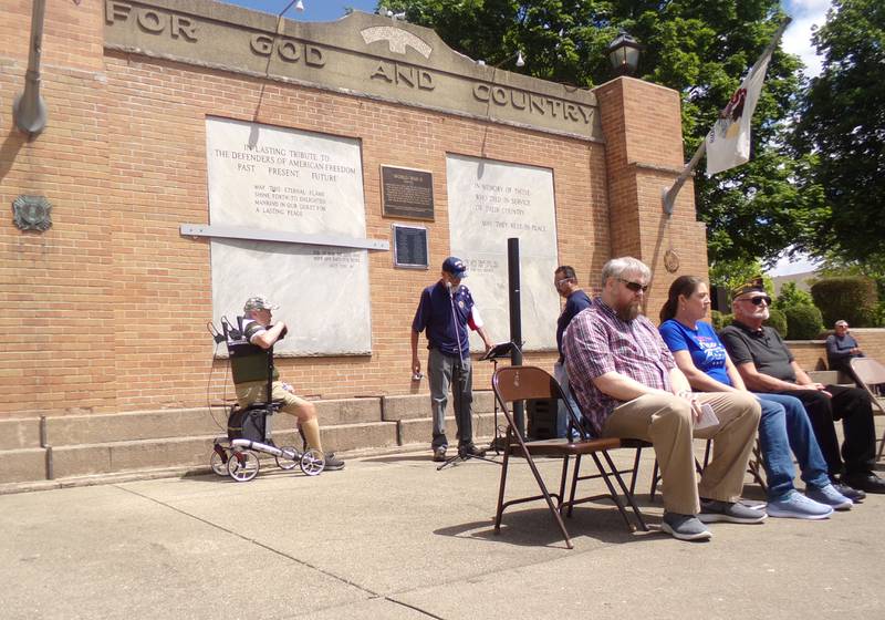 Dan Austin (at the microphone) sings "Arlington" by Trace Adkins on Monday, May 27, 2024, during the Memorial Day ceremony at Veterans Memorial Plaza in Streator's City Park.