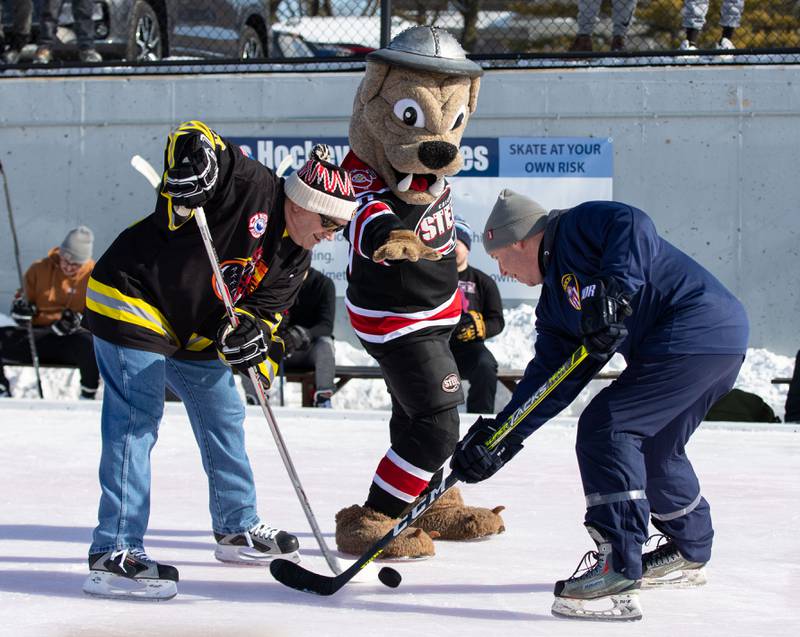 The Chicago Steel Mascot, Rusty, drops the puck at the start of the Wheaton Police Department and Fire Department’s game during the Wheaton Park District's Ice-A-Palooza at the Central Athletic Complex in Wheaton on Saturday, Feb. 4, 2023.
