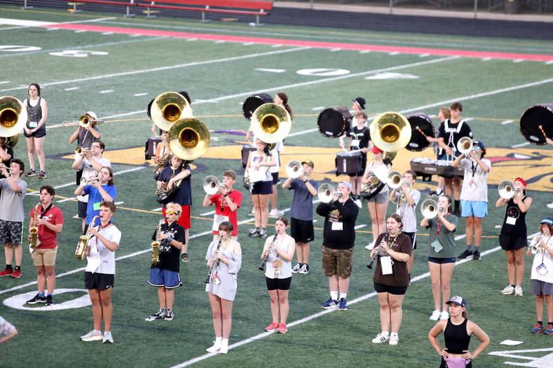 Members of the Batavia High School marching band walk through their choreography with their instruments during band camp at the school on Tuesday, July 30, 2024.