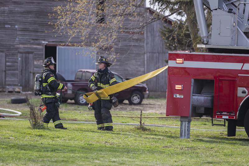 Firefighters work at the scene of a fire that broke out Monday, April 14, 2025, near Harmon.