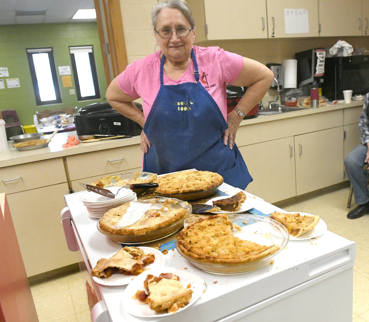 Gail Beck of Chana, one of the pie baking crews for the Chana United Methodist Church, stands over some of the selection offered at the Oregon Woman's Club Antique Show in Oregon. Homemade pies were just one of the items sold by church volunteers at the show's concession stand.