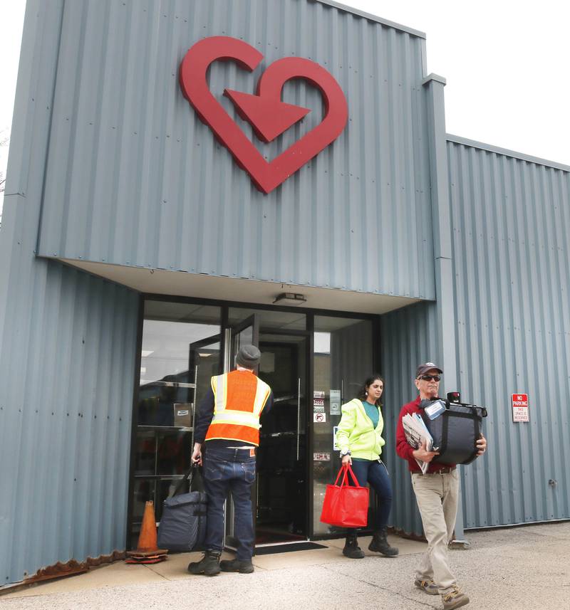 Volunteers pick up a their Meals on Wheels deliveries to distribute Tuesday, April 23, 2024, at the Voluntary Action Center in Sycamore. VAC is celebrating its 50th anniversary this year.