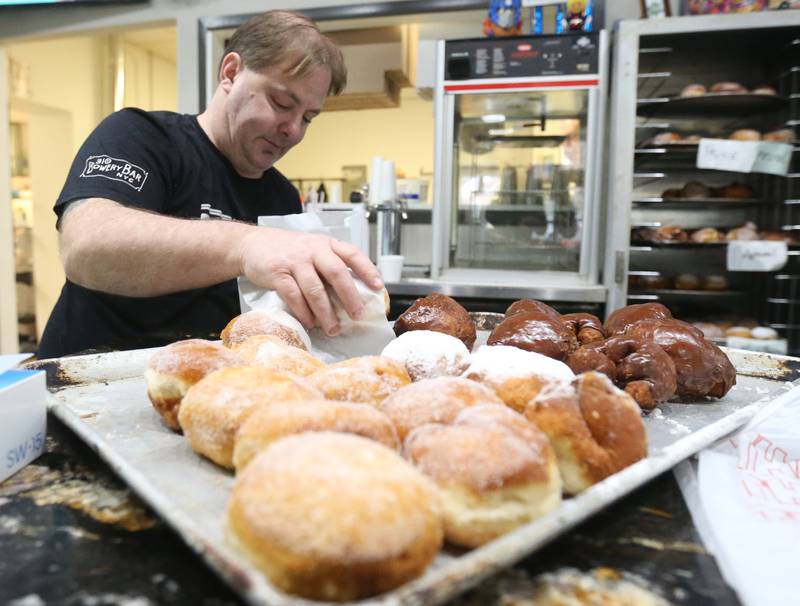 Mike Kaminski owner of Bobaluk's, fulfills orders of Paczki's at his restaurant on Tuesday, March 4, 2025 in Marseilles.