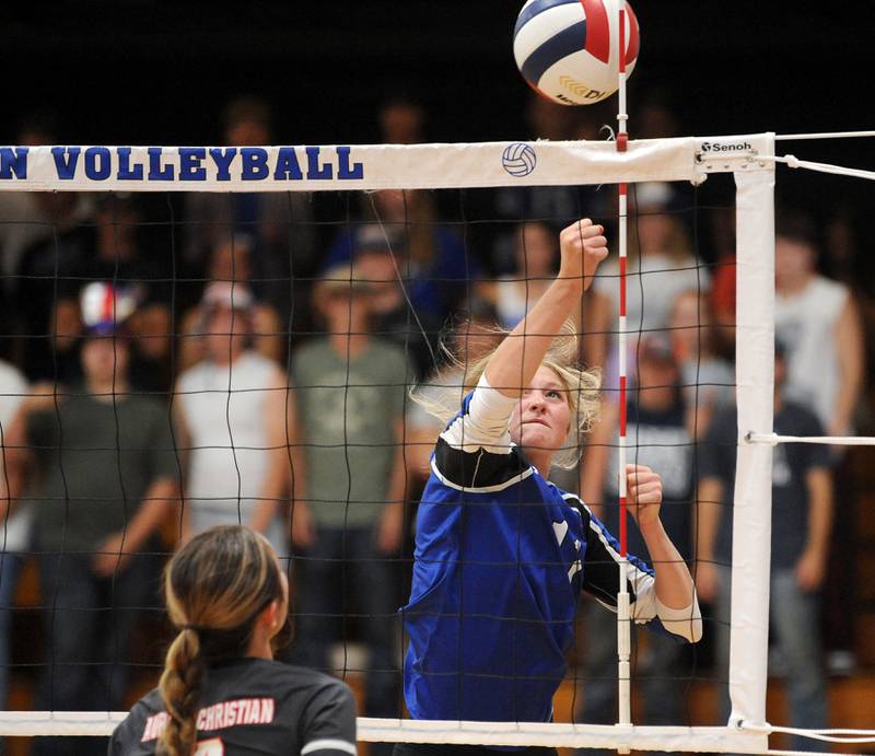 Newark's Adrianna Larson punches the ball over the net against Aurora Christian defender Avery Borowski during a girls' volleyball match at Newark High School on Tuesday, Sep. 5, 2023.