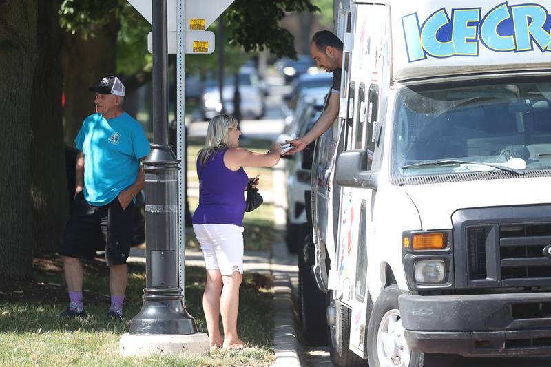 A lady gets an ice-cream while walking between the festivities at Plainfield Fest on Saturday June 29, 2024.