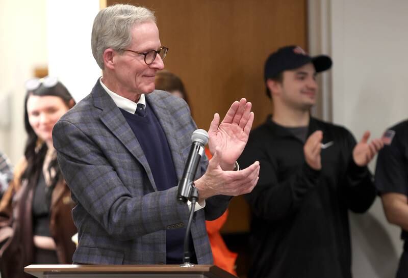 DeKalb City Manager Bill Nicklas applauds as he introduces acting DeKalb Fire Chief Michael Thomas to be sworn in as the city's new full-time fire chief Monday, April 11, 2022, during the DeKalb City Council meeting at the library. Thomas has been serving as the acting chief since the retirement of former chief Jeff McMaster in November.