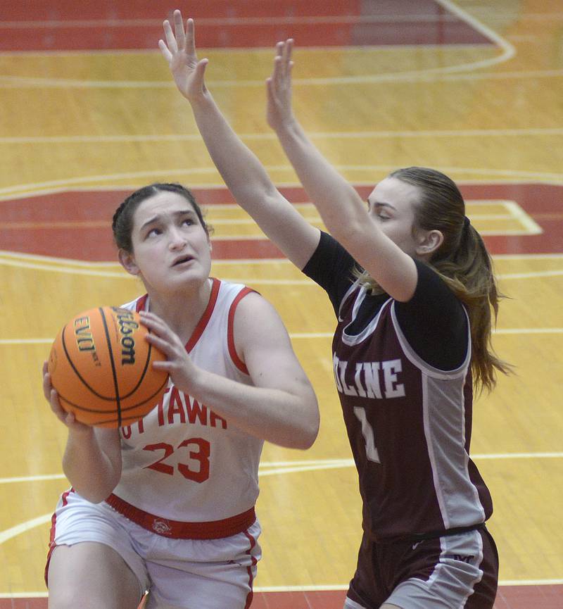 Ottawa’s Mary Stisser drives to the net as Moline’s Adalynn Voss  attempts to block in the 1st period Tuesday at Ottawa.