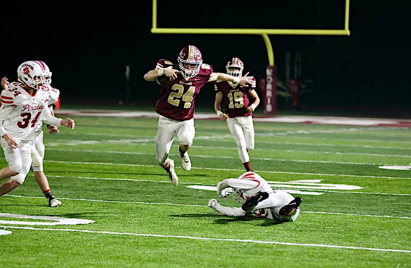 Morris' Ashton Yard leaps over an Ottawa defender Friday night in a 49-0 win. Yard had 178 yards and three touchdowns on 10 carries.