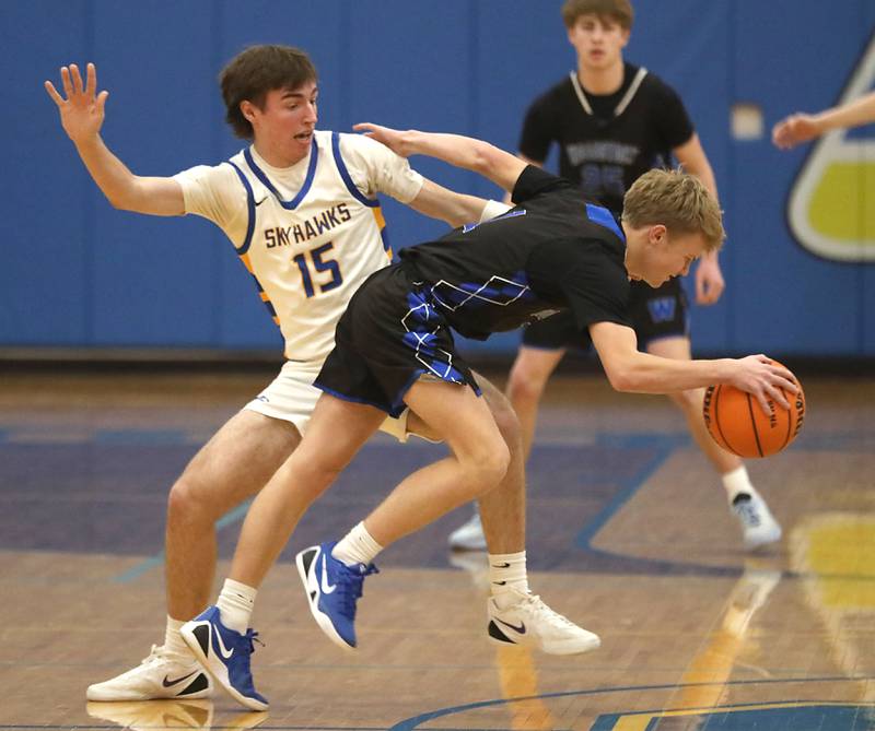 Woodstock's Rian Hahn Clifton tries to keep control as he dribbles past Johnsburg's Ashton Stern during a Kishwaukee River Conference boys basketball game on Friday, February. 13, 2026, at Johnsburg High School.