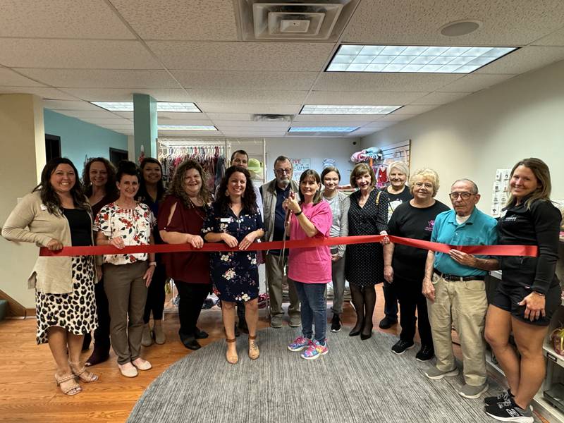 Hearts With Compassion Founder Kim Przybyla cuts the ribbon to their new location with Channahon Minooka Chamber/Grundy County Chamber staff and Ambassadors, as well as with Mayor Ric Offerman April 16.