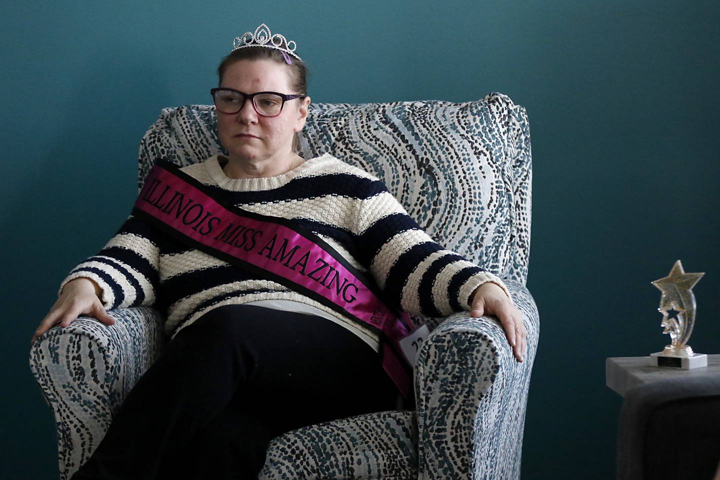 Kris Klemme listens as her friends Brittany Woods, Jackie Medina, and Sammi Huffman talk in their home on Tuesday, March 13, 2025. The home is Clearbrook's new community integrated living arrangement home for adults with developmental disabilities in Woodstock.
