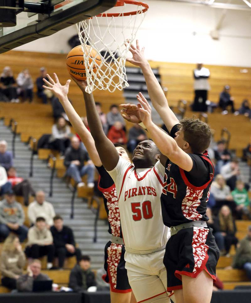 Palatine's Tony Balanganayi (50) goes to the hoop past Glenbard East's Sam Walton (24) during the 51st Jack Tosh Holiday Classic basketball tournament Monday, Dec. 29, 2025 at York High School in Elmhurst.