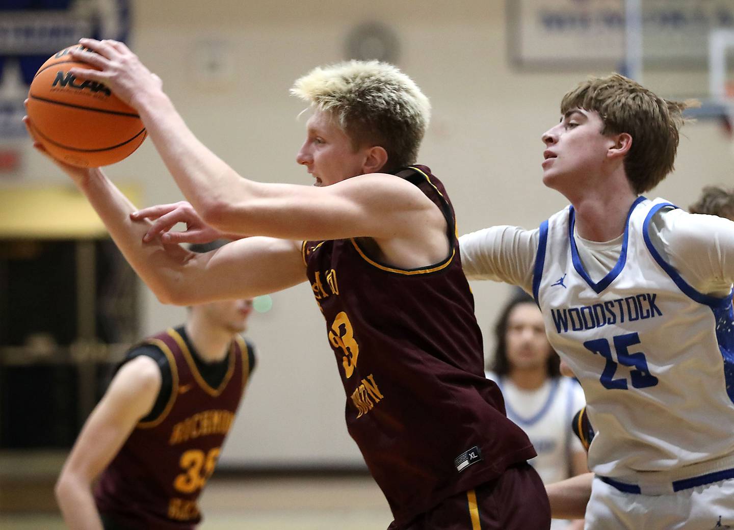 Richmond-Burton's Luke Robinson grabs a rebound in front of Woodstock's Liam Laidig during a Kishwaukee River Conference boys basketball game on Wednesday, February. 4, 2026, at Woodstock High School.