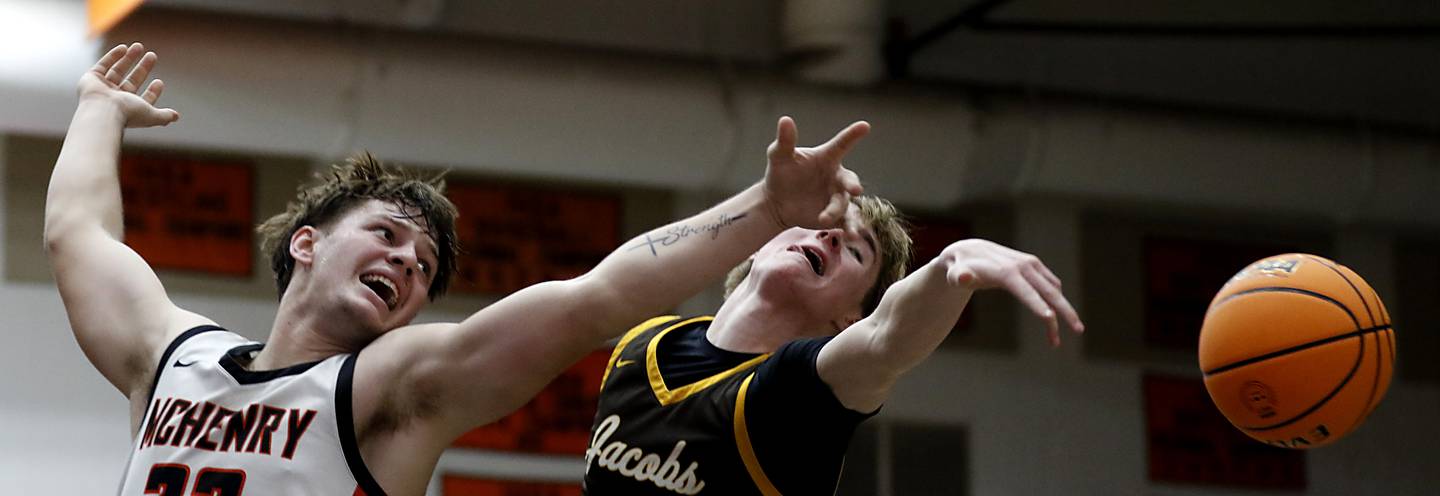 McHenry's Conner McLean and Jacobs' Connor Goehring watch as a rebound bounces out of their reach during an IHSA Class 4A McHenry Regional basketball game on Wednesday, Feb. 26, 2025, at McHenry High School.