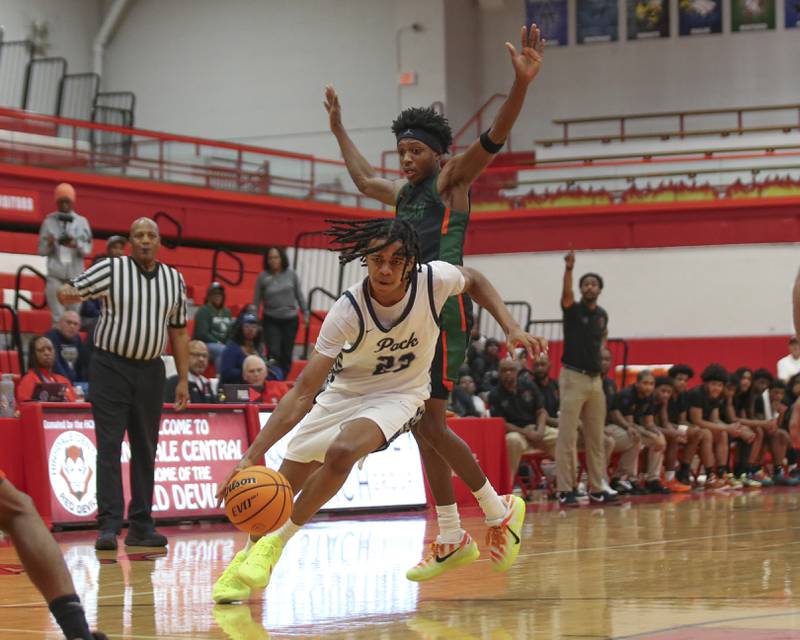 Oswego East's Mason Lockett (23) drives to the basket during their Hinsdale Central Holiday Classic basketball game between Morgan Park at Oswego East Saturday, Dec 27, 2025 in Hinsdale.