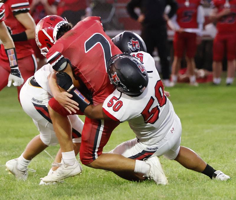 Panther seniors #50 Jordae Crow and #1 Keegan Winckler team up to stop #7 Red Devil senior quarterback Dylan Glenn Friday night at Hall High School. The Panthers picked up their 2nd win for the season with a 19-7 victory over the Red Devils.